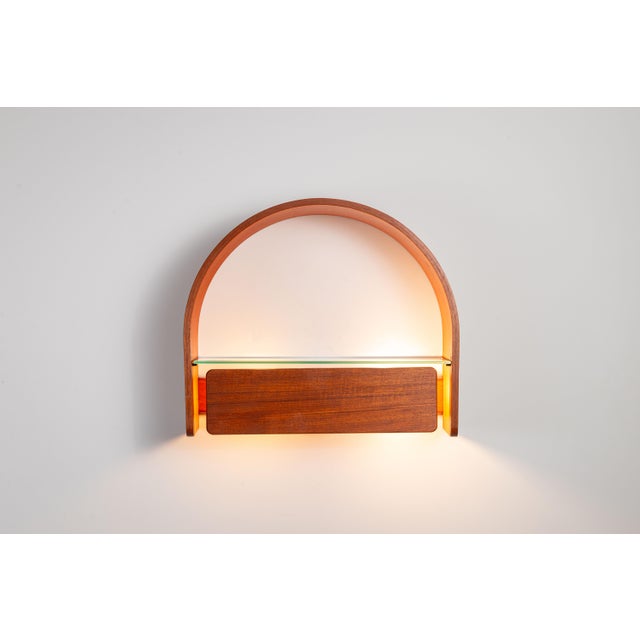 This unique vintage wall console produced by Domus, beautifully merges functional design with warm, atmospheric lighting....