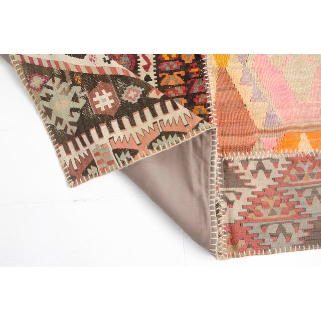This is a vintage Turkish Oushak rug from the Mid 20th Century. The piece was hand-knotted.