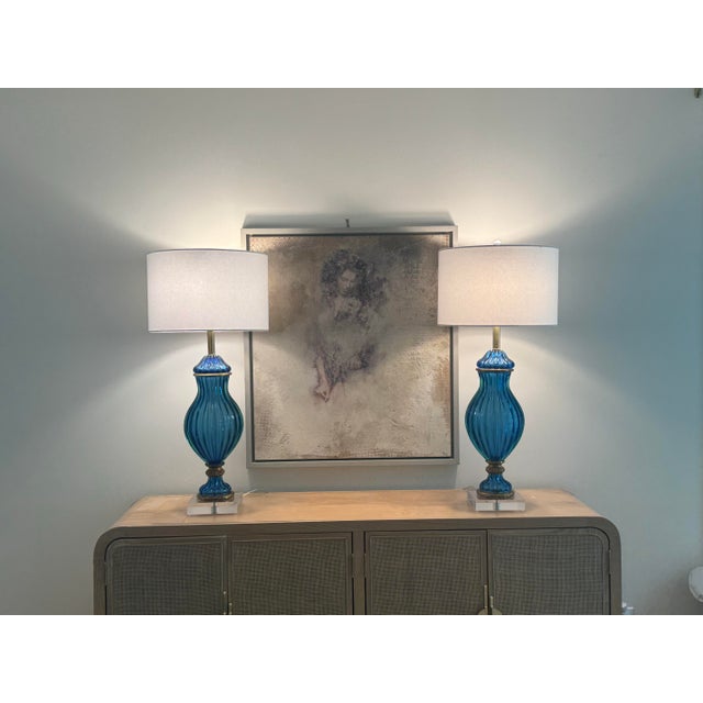 Wow! Absolutely stunning pair of Marbro blue Murano art glass double socket table lamps with brass trim. As you can see in...