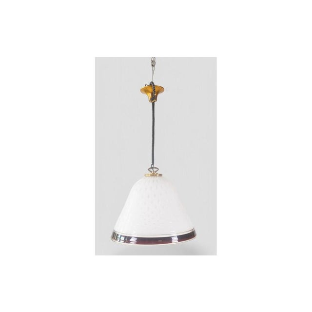 This elegant pendant lamp, made in Italy in the 1960s, is a true example of Murano glass craftsmanship. The white cased...