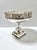 Graceful swans glide among cattails and reeds in the beautifully detailed pierced gallery of this vintage silverplate...