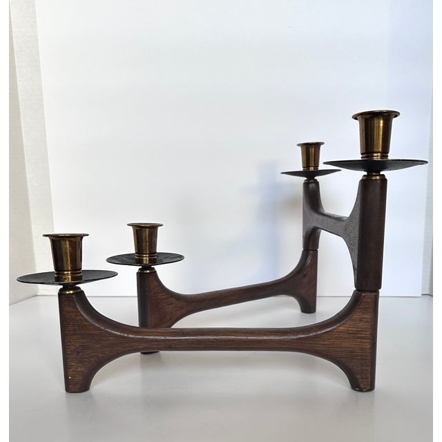 Mid-20th century Danish candle holder with articulating arms in teak wood and brass. Holds four traditional size tapers in...