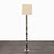 This Arteriors floor lamp features a striking column base with a unique mixed horn finish, showcasing natural patterns in...