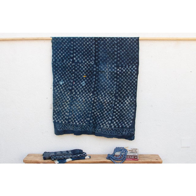 A masterwork of Malian textile heritage featuring deep indigo saturation and symbolic geometric motifs. Originating from...