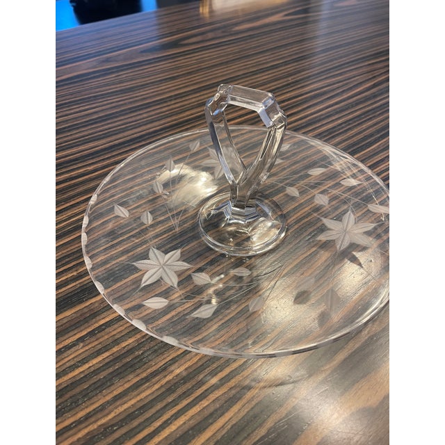 Vintage cut glass serving tray with fluted edges and keyhole carrying handle. Petite and elegant, the unique design makes...