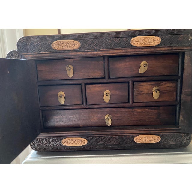 This exquisite jewelry box is a true masterpiece of Chinese vintage art. The rich, warm tones of the rosewood and the...