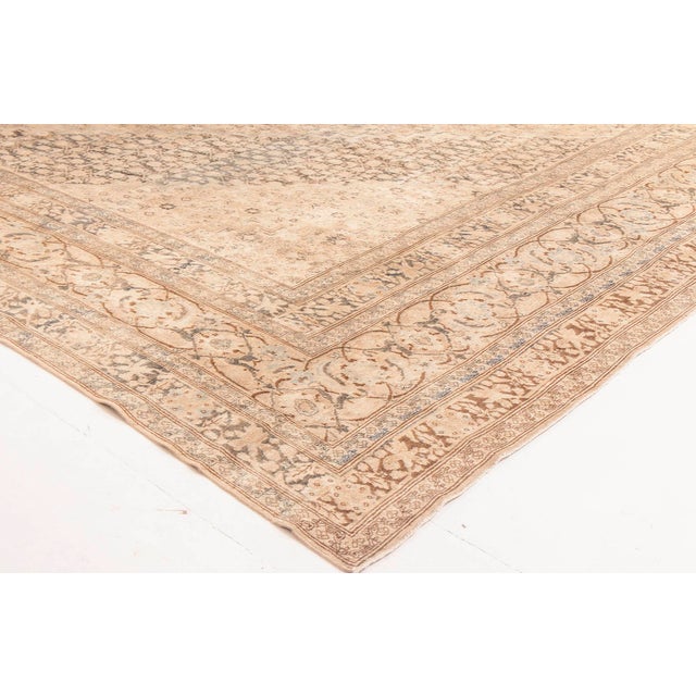 A masterwork of Persian weaving from the city of Tabriz, this oversized antique rug from circa 1900 exemplifies the...