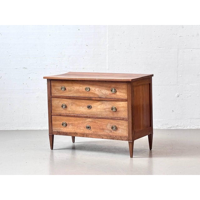 An elegant antique chest of drawers in a classicist style, stylistically belonging to the Directoire or early Biedermeier...