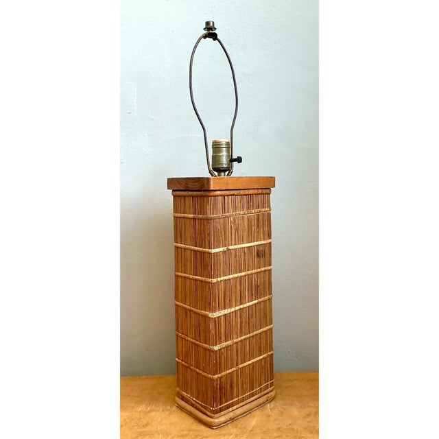 This vintage Mid-Century Modern table lamp beautifully exemplifies the timeless appeal of classic rattan craftsmanship....