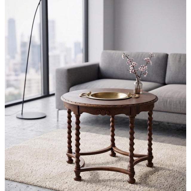 Circular coffee table crafted from solid stained oak, dating from the first half of the 20th century. The design is...