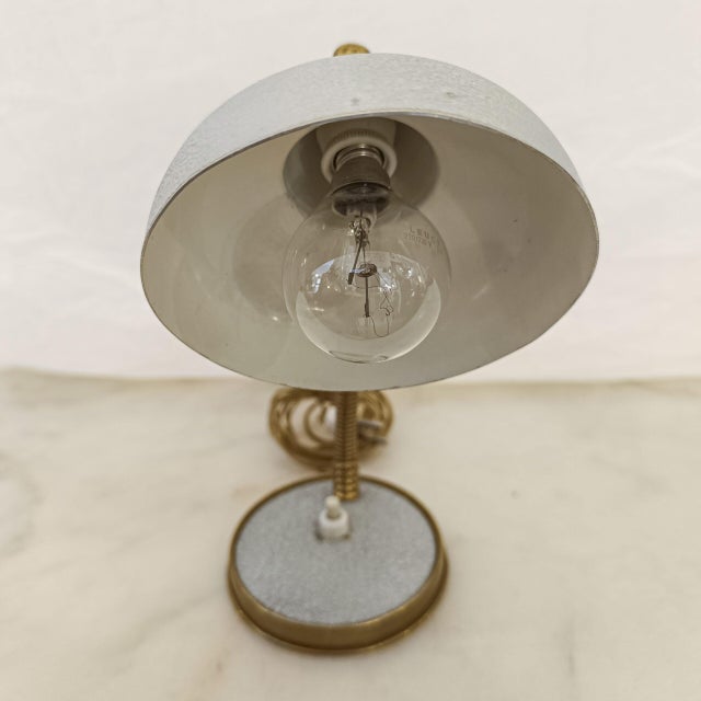 A small, original 1940s table lamp from England, made by Salar. Its all-metal structure combines brass for the trim and...