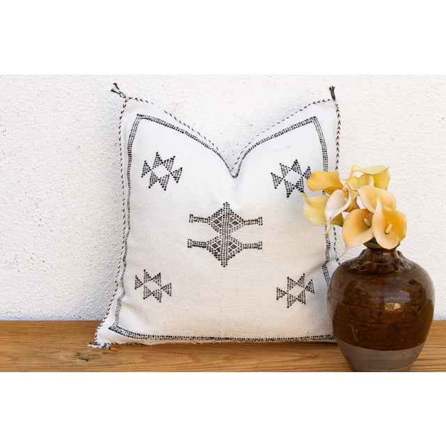 Two stacked star motifs run vertically down the center of this handcrafted Moroccan cactus silk pillow, hand-stitched in...