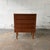 A Danish teak chest from the 1960s with four wide drawers, slim integrated pulls, and tapered legs. The front is kept...