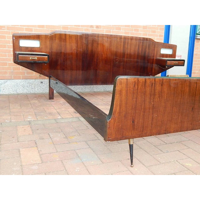 50's double bed in rosewood, black metal and brass feet. headboard with lighted nightstands.
