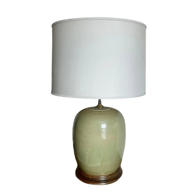 Antique celadon ginger jar, converted into a two-light table lamp. Crackled glaze over a luminous tone of green, mounted...