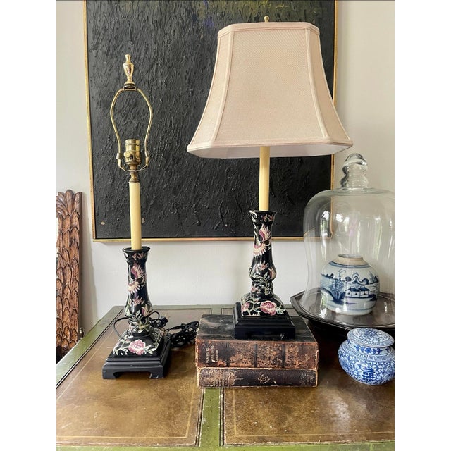 Lovely pair of lamps by Bradburn Gallery, presented in a deep, dark ebony, black ceramic candlestick shape with a pattern...