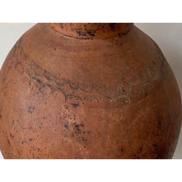 Old tinaja of Calanda (Teruel), Spain. Made of red clay with handcrafted semi circular figures. A "tinaja" is an oval...