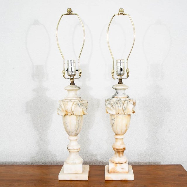 Pair of Italian alabaster carved table lamps. Beautiful veining throughout the stone. Unmarked examples.