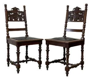 Early 20th Century Antique Spanish Revival Carved Oak Side Chairs With Crest Motif & Leather Seats - A Pair
