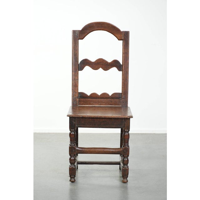 Beautifully designed 18th-century French antique Lorraine chair made of oak with warm and deep colors. : This elegant...
