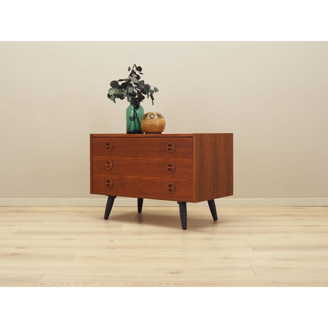 The chest of drawers was made in the 1960s, Danish production. The structure is covered with teak veneer. Legs made of...