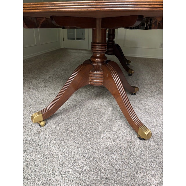 Replica of a George Hepplewhite dining table with 3 extension leaves (18" each). Rosewood veneer top with black and white...