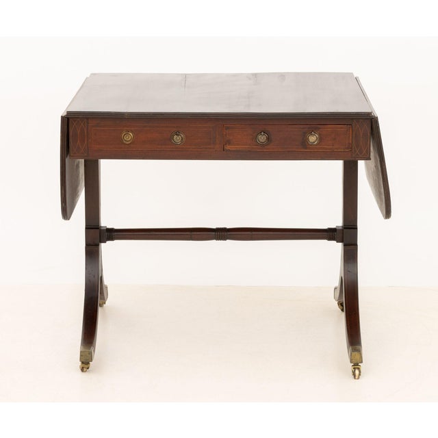 George III Mahogany Sofa Table, with one short drawer and one faux drawer on each side above four downswept legs with...