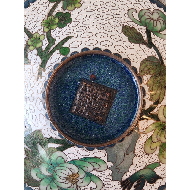 6in Chinese Enamel Cloisonne plate featuring birds and flowers. Square stamped marking on back signifying maker or studio.