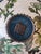 6in Chinese Enamel Cloisonne plate featuring birds and flowers. Square stamped marking on back signifying maker or studio.