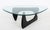 Isamu Noguchi Style Amorphic Coffee Table, rounded edge triangular glass top above ebonized hinged wood base, marked...