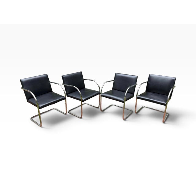 A set of four authentic Brno tubular chairs, the iconic cantilever design created by Ludwig Mies van der Rohe in 1930 and...