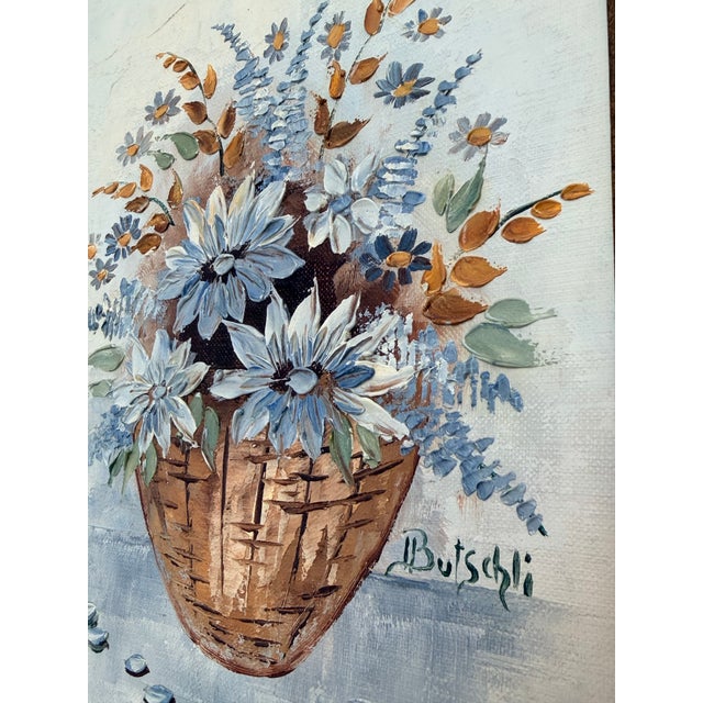 Original Canvas oil painting of flowers and greenery in a basket. Signed by artist Irene Butschli. Artwork 8”x 10” canvas...