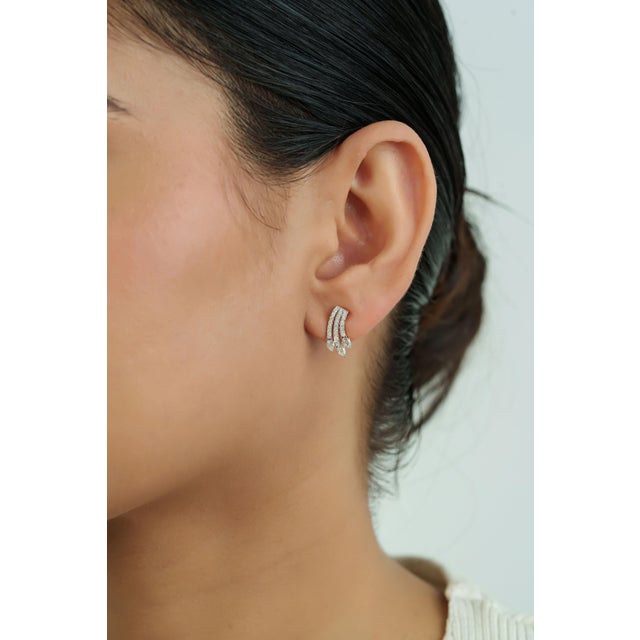 These stud earrings feature 0.66 carats of diamonds set in 14K Yellow Gold. The design showcases a combination of pear-cut...