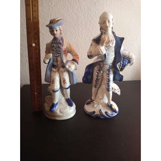 These are Blue & White 8" Victorian Porcelain Figurines Likely German Set of 2 Pricured at an auction