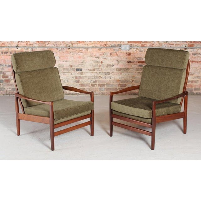 A pair of mid century afromosia armchairs by cintique, circa 1960s. Newly reupholstered with green fabric. Excellent...