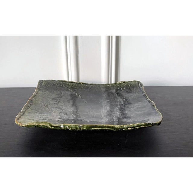 An Oribe-Style rectangular dish with a slightly concaved slab body and up-turned irregular edges, made by Kitaoji Rosanjin...