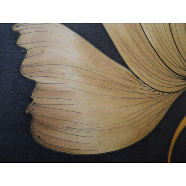 Silk painting of a ginkgo leaf with very fine outlines and gradations of earthy or amber tones on a black background....
