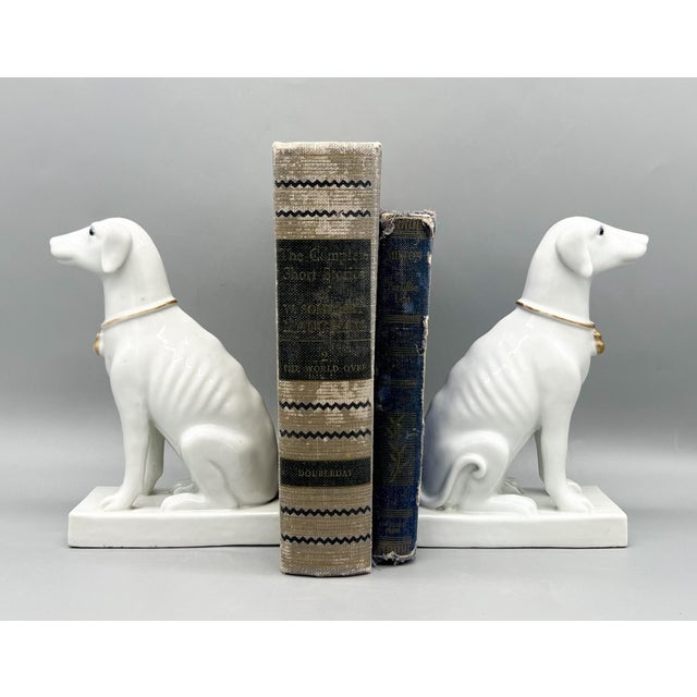 Exquisite pair of vintage porcelain greyhounds (or whippets), featuring sleek sculpted forms and refined detailing. Each...