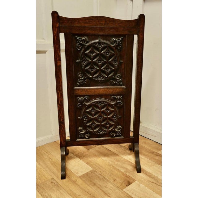 Carved Gothic oak panelled fire screen. This sturdy screen has 2 heavy carved panels set in an oak frame. The screen is in...