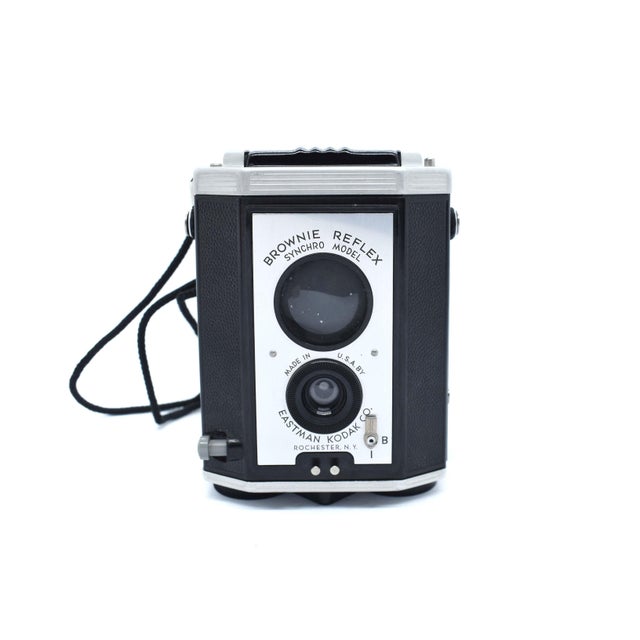 Step back in time with the Kodak Brownie Reflex Synchro Model, a quintessential piece of photographic history from the...
