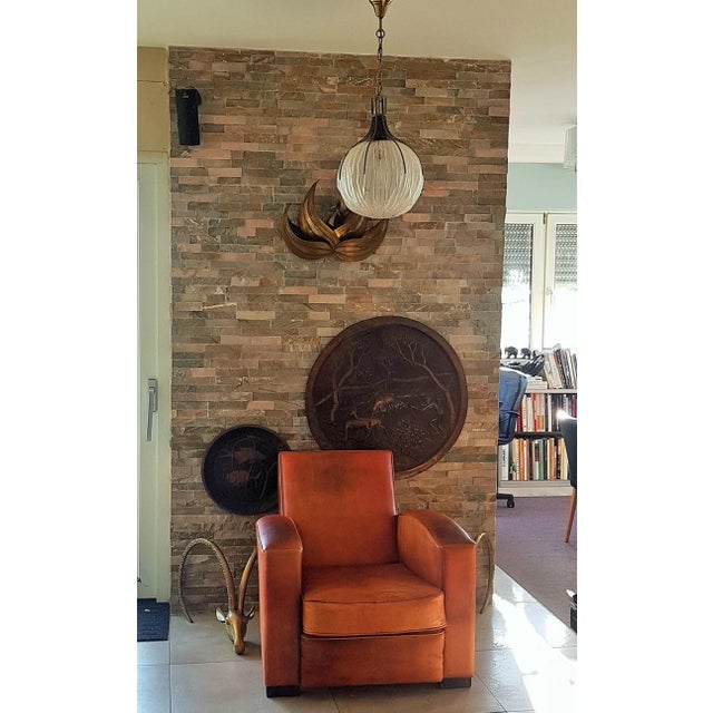 Hanging lamp from the middle of the century. Matted and structured glass ball with a brass claw version, by the Italian...