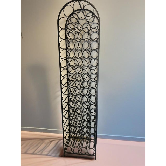 Arched wrought iron wine rack accommodating 67 wine bottles designed by Arthur Umanoff for Shaver Howard and distributed...