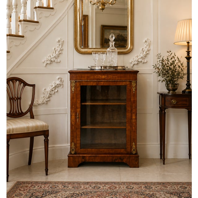 An antique Victorian walnut inlaid glazed pier cabinet of excellent colour and elegant proportions. Finely crafted in...