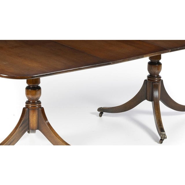 Dining table - 19th century. English, 19th century; made of mahogany wood. Rectangular top supported by two column-shaped...