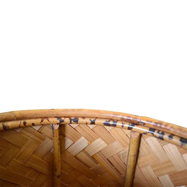 A lovely chinoiserie round hamper basket with lid. Created from burnt bamboo and woven natural fibers, this basket will be...