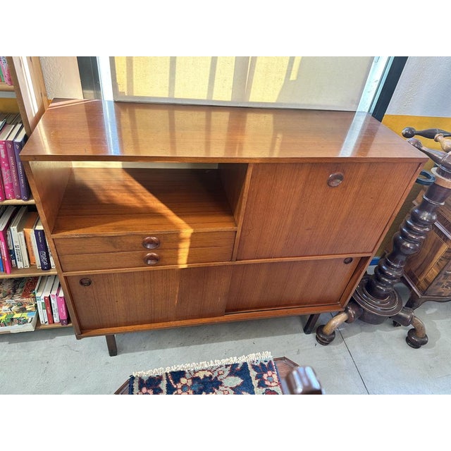 1960's Teak belief. It has a large shelf with 2 drawers underneath, one covered in velvet and one entirely in wood, on the...