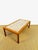 Elegant Scandinavian-inspired coffee table from the 1960s. The frame is made of solid teak and teak veneer, offering a...