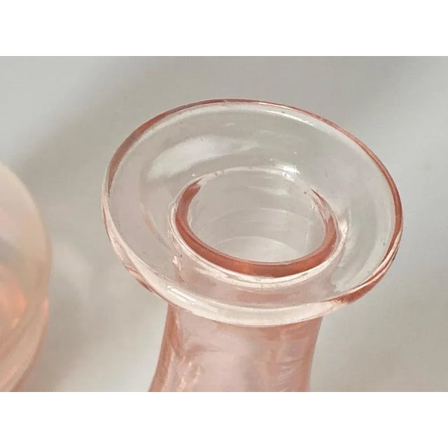 This glass decorative bottle, has been made in France circa 1940. They are typical Art Deco Style shape, in a pink color.