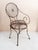 Fabulous wrought iron garden chair with the distinct spiral pinwheel design on the back and seat. Spring seat. Traces of...