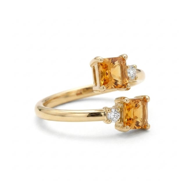 Elegant, modern, and deeply romantic. This beautiful "Toi et Moi" (You and Me) bypass ring features two vibrant 4x4mm...